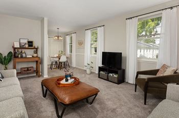 a living room with a couch and a table in front of a tv
